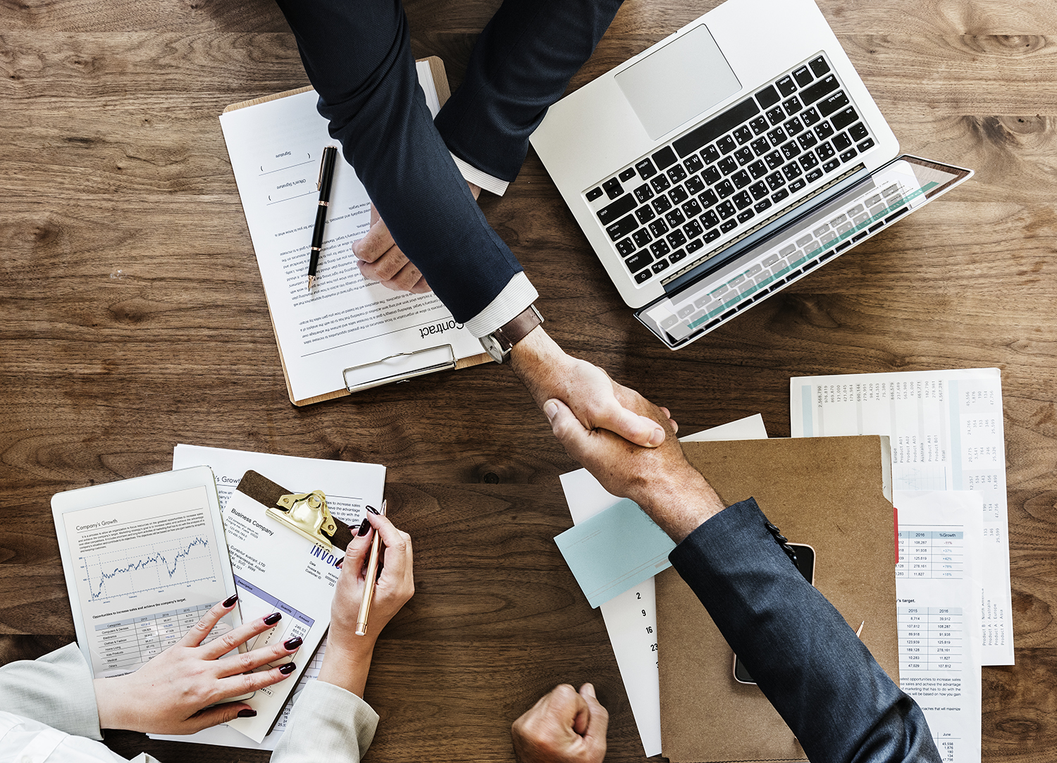 Businesspeople shaking hands together